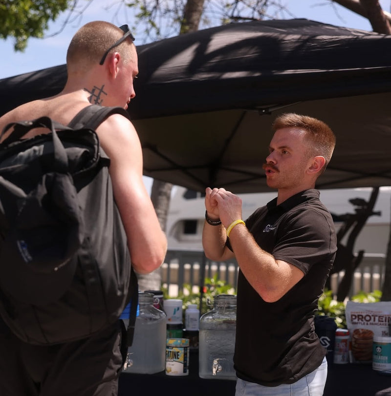 Man explaining the benefits of dietary supplements to a consumer—engaging in a conversation about health, wellness, and personalized nutrition choices.